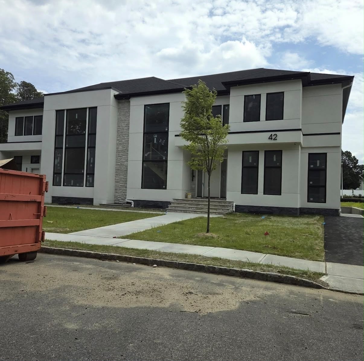 Modern two-story stucco home where HD Installs wired security cameras and access control